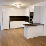 Modern L-Shaped Kitchen with Wood Accents